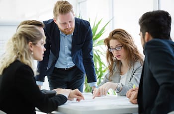 Colleagues having discussion at conference table